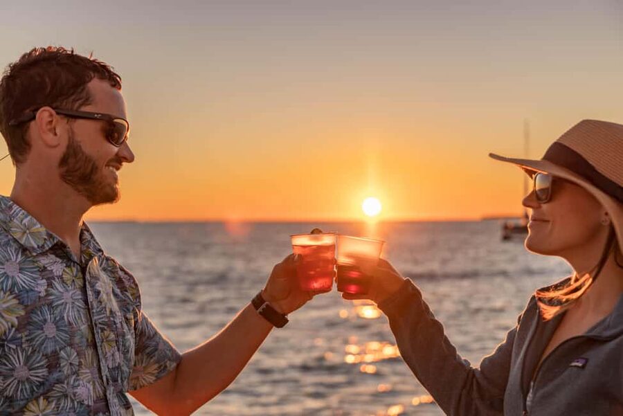 Key West Signature Sunset Cruise with Open Bar, Food & Music - The fun, hands-on moment: sails and photo requests